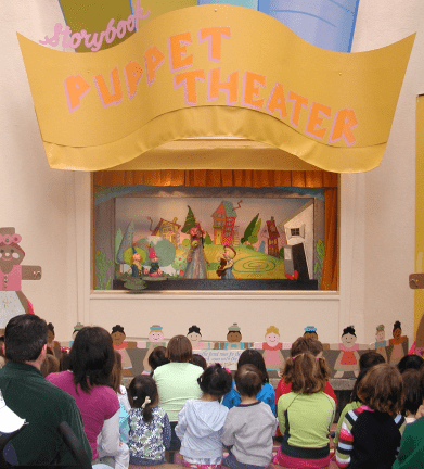 Children watching at a puppet show